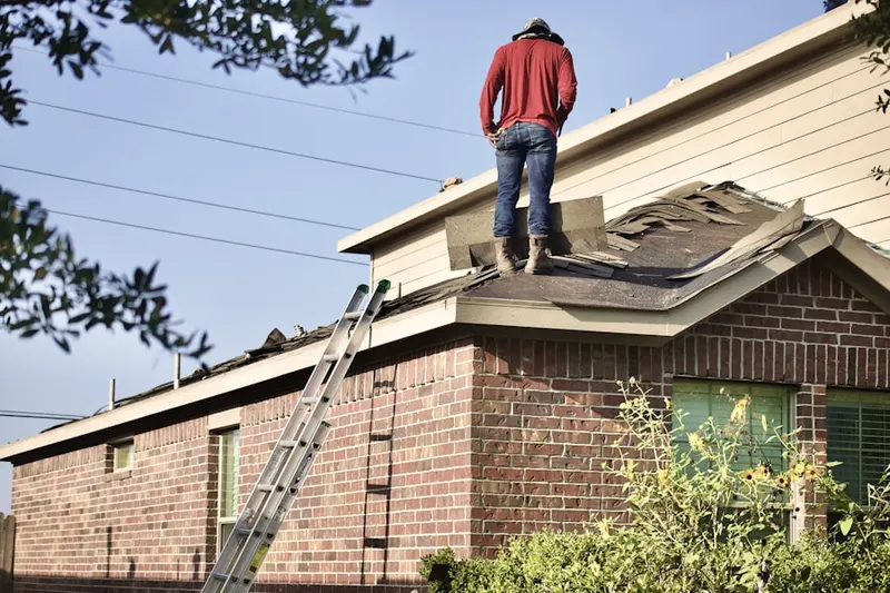 Professional roofer working on a residential roof in Crockett
